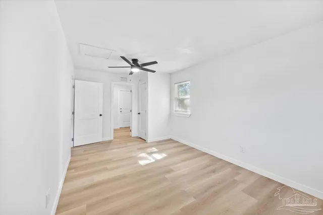 a view of a livingroom with a ceiling fan and window