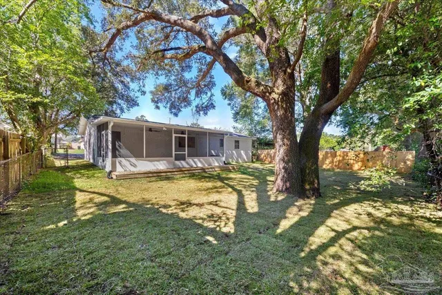 a view of a house with swimming pool and a yard