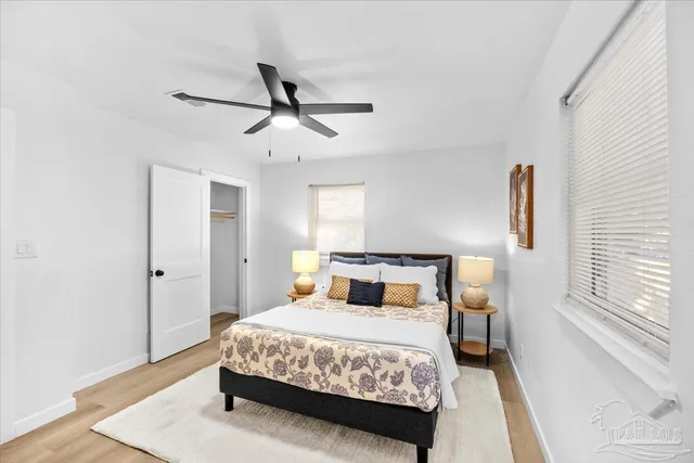 a bedroom with a bed and wooden floor