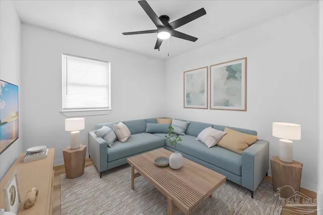 a living room with furniture and a wooden floor