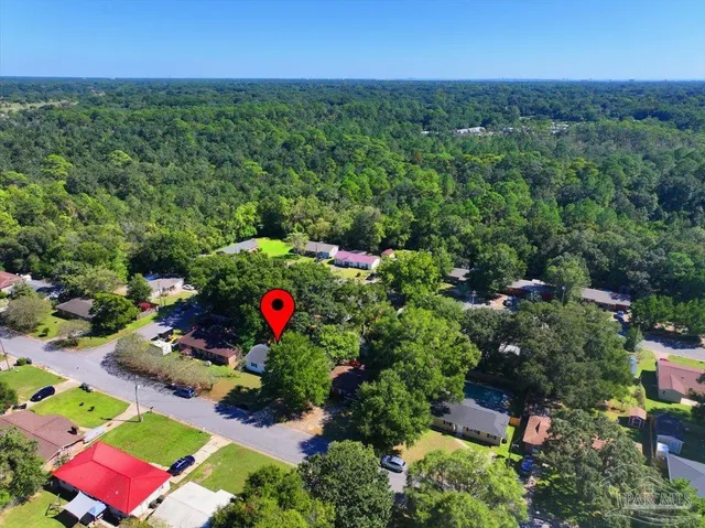 an aerial view of a houses with city view
