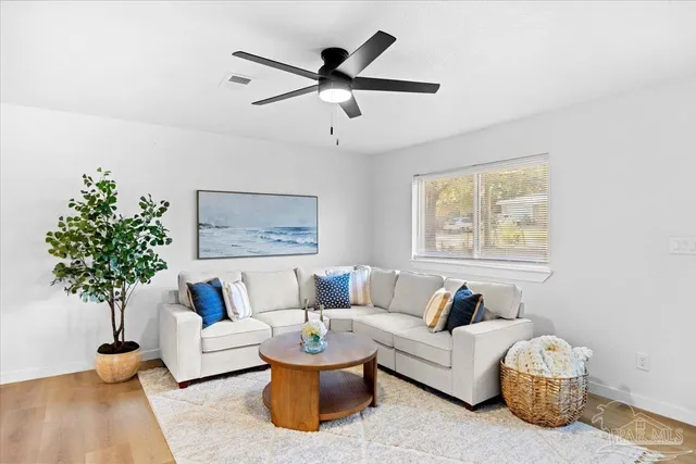 a living room with furniture and a potted plant