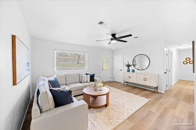 a living room with furniture a window and a chandelier
