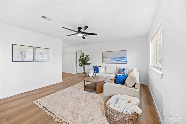 a living room with furniture and wooden floor