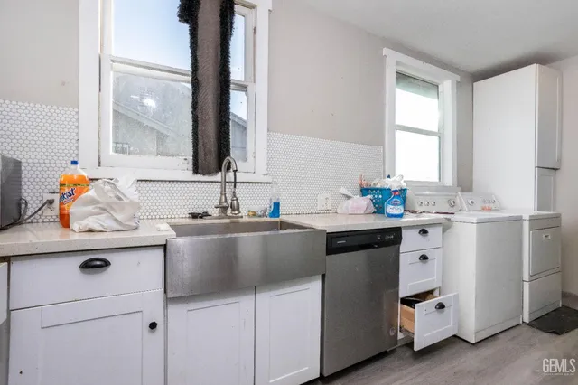 a kitchen with sink and cabinets