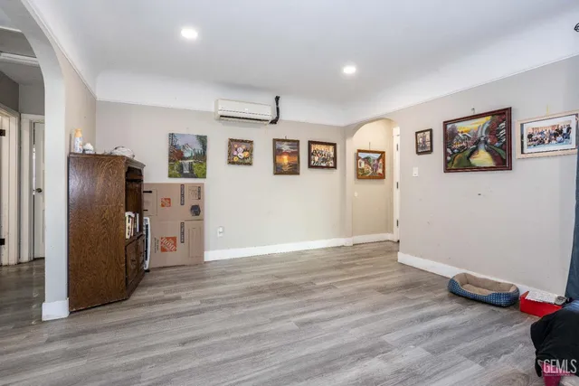 a view of a kitchen with wooden floor and a refrigerator