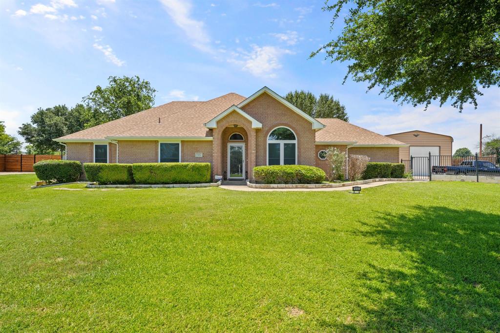 a front view of house with yard and green space