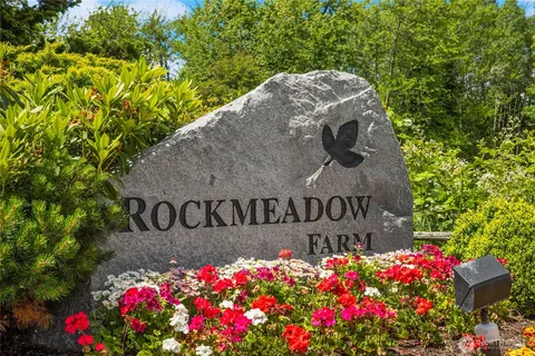 a sign that is in front of flowers