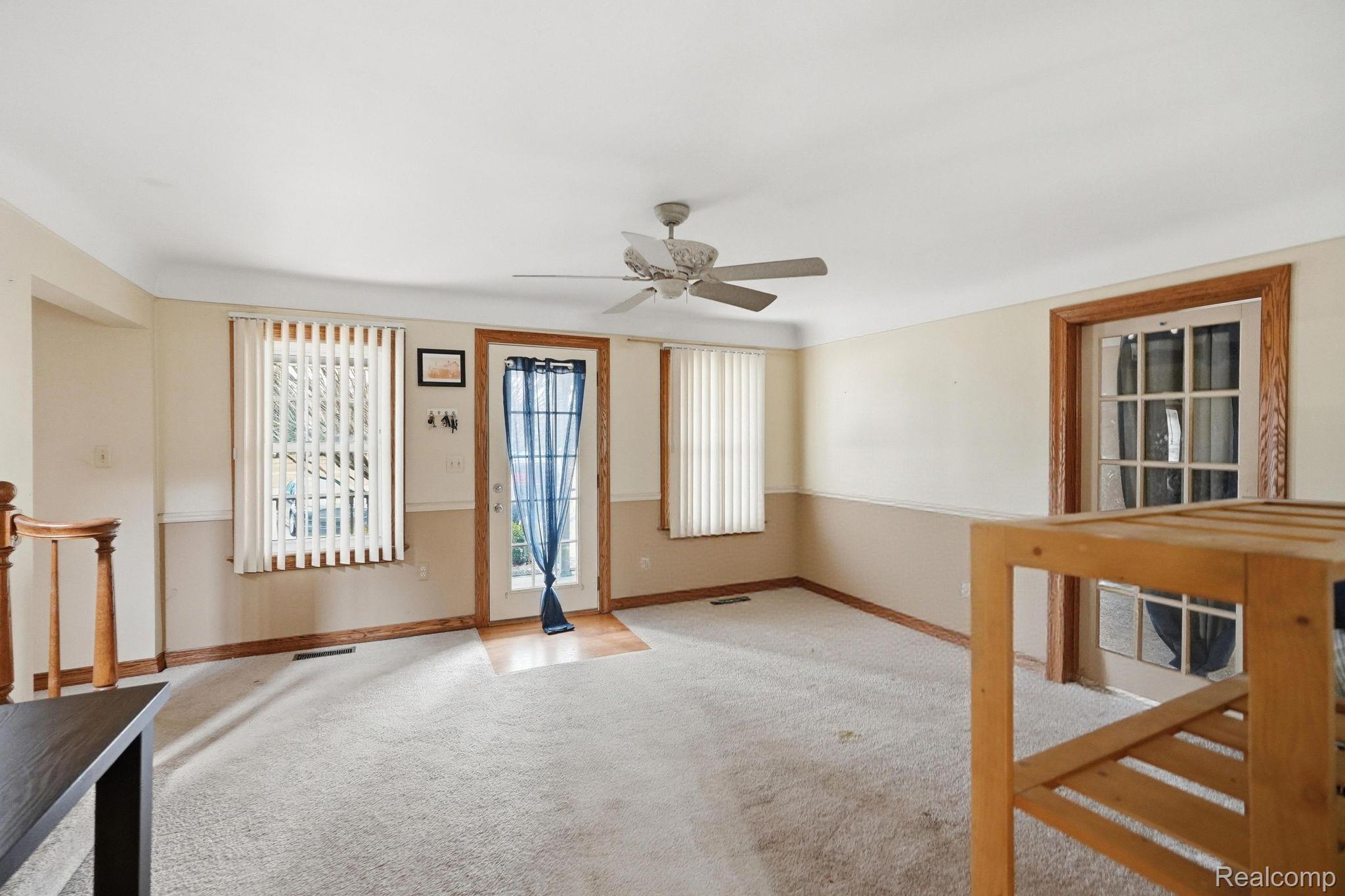 49777 Card Road Macomb, MI 48044 - Photo 7 of 18 Spare room featuring a ceiling fan and carpet floors