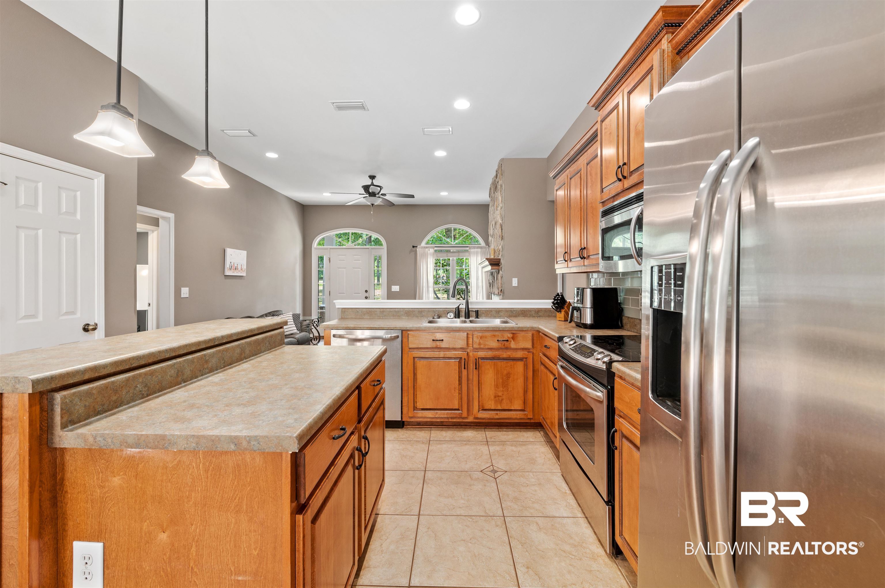 15240 Styx River Road Stapleton, AL 36578 - Photo 13 of 18 Kitchen featuring stainless steel appliances, pendant lighting, sink, and a center island