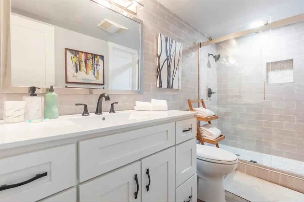 137 Laurel Mountain Road, Unit 418 Mammoth Lakes, CA 93546 - Photo 14 of 23 Bathroom featuring vanity, a stall shower, and tile walls