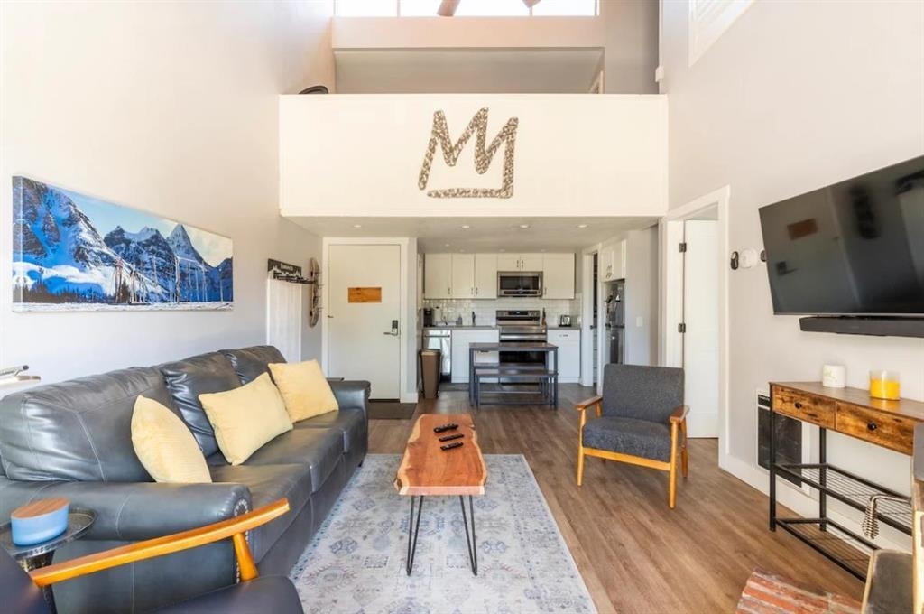 137 Laurel Mountain Road, Unit 418 Mammoth Lakes, CA 93546 - Photo 2 of 23 Living area featuring wood finished floors and a high ceiling