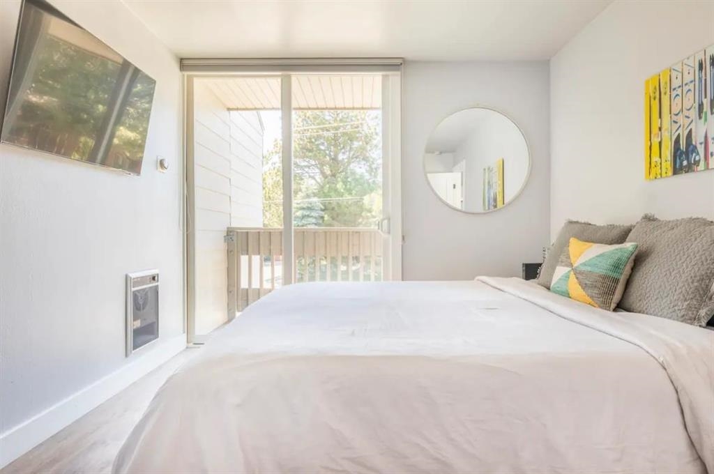 137 Laurel Mountain Road, Unit 418 Mammoth Lakes, CA 93546 - Photo 8 of 23 Bedroom with access to exterior, wood finished floors, and heating unit