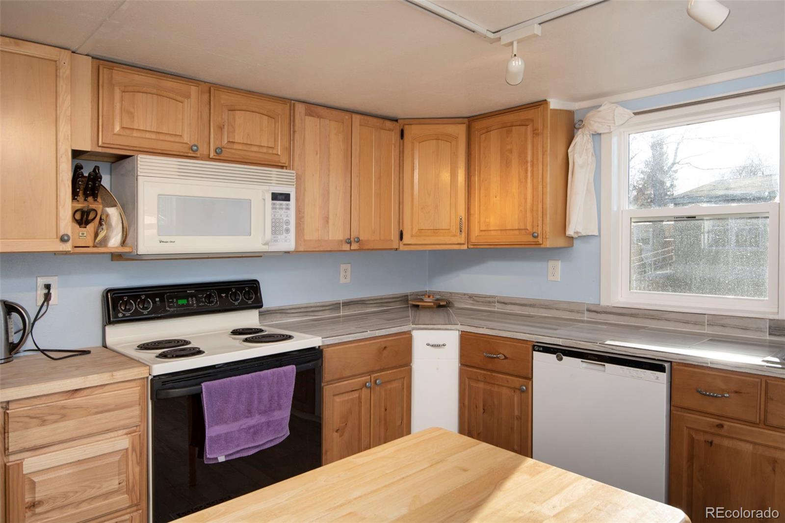 5000 Butte Boulder, CO 80301 - Photo 6 of 30 a kitchen with stainless steel appliances granite countertop a sink stove and microwave
