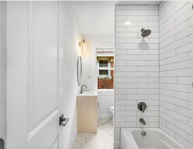 a bathroom with a bathtub and shower