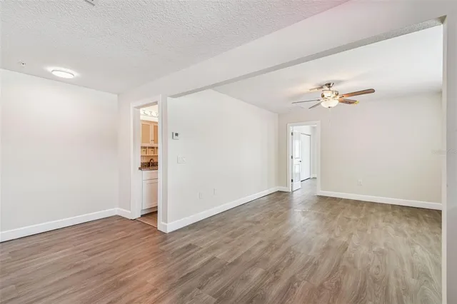 a view of an empty room with wooden floor