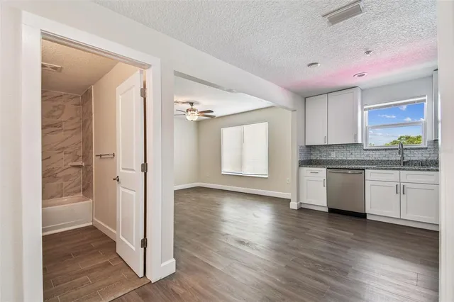 a kitchen with stainless steel appliances granite countertop a refrigerator and a stove top oven
