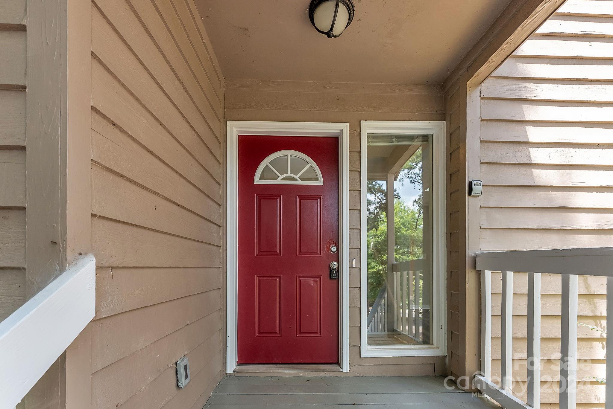 1018 Palmyra Drive Tega Cay, SC 29708 - Photo 14 of 36 a view of front door with a red door and wooden door