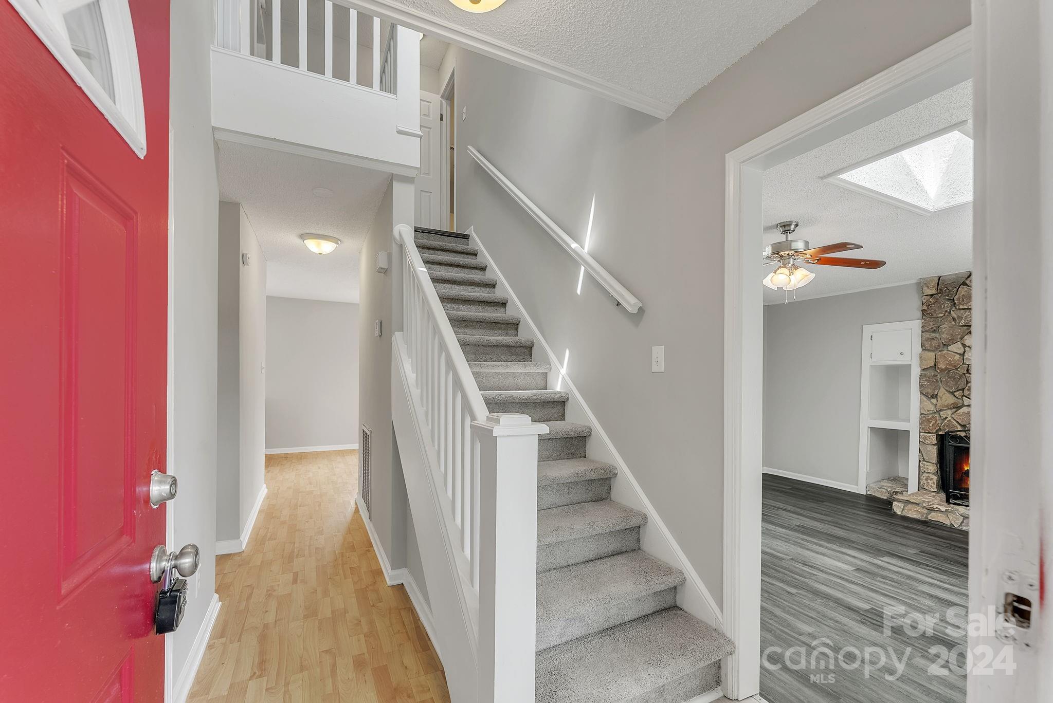1018 Palmyra Drive Tega Cay, SC 29708 - Photo 15 of 36 a view of a hallway with wooden floor and staircase