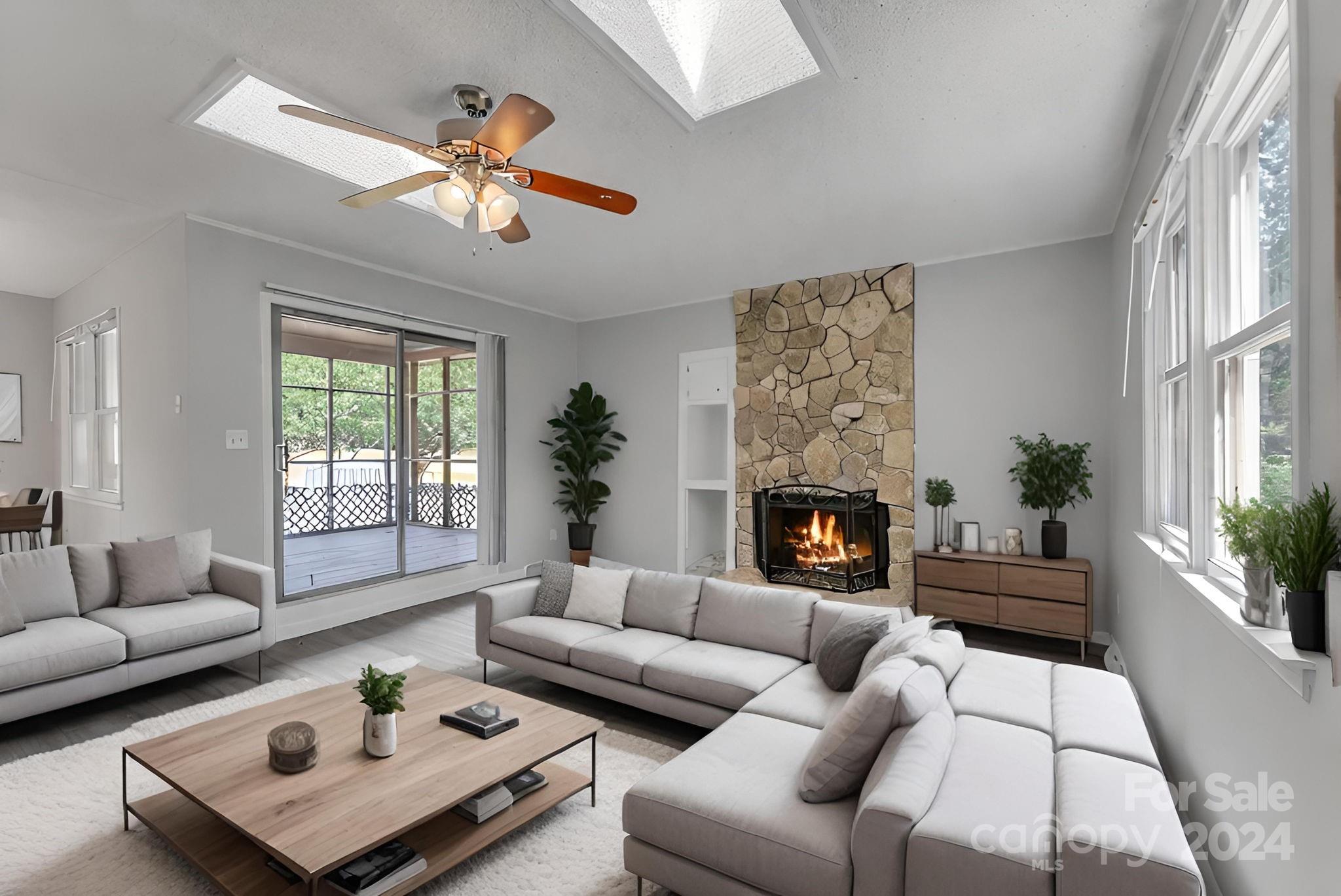 1018 Palmyra Drive Tega Cay, SC 29708 - Photo 16 of 36 a living room with furniture a fireplace and a large window