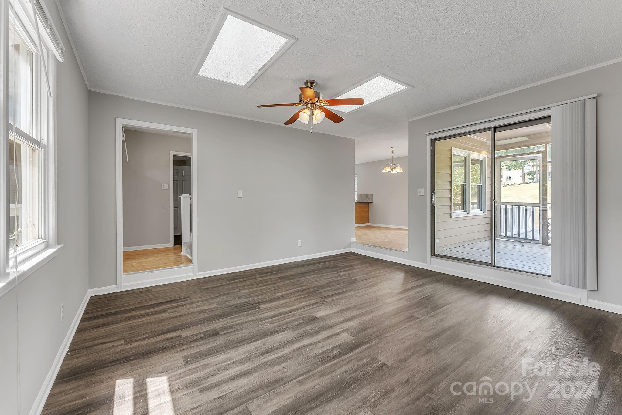 1018 Palmyra Drive Tega Cay, SC 29708 - Photo 18 of 36 a view of an empty room with window and wooden floor