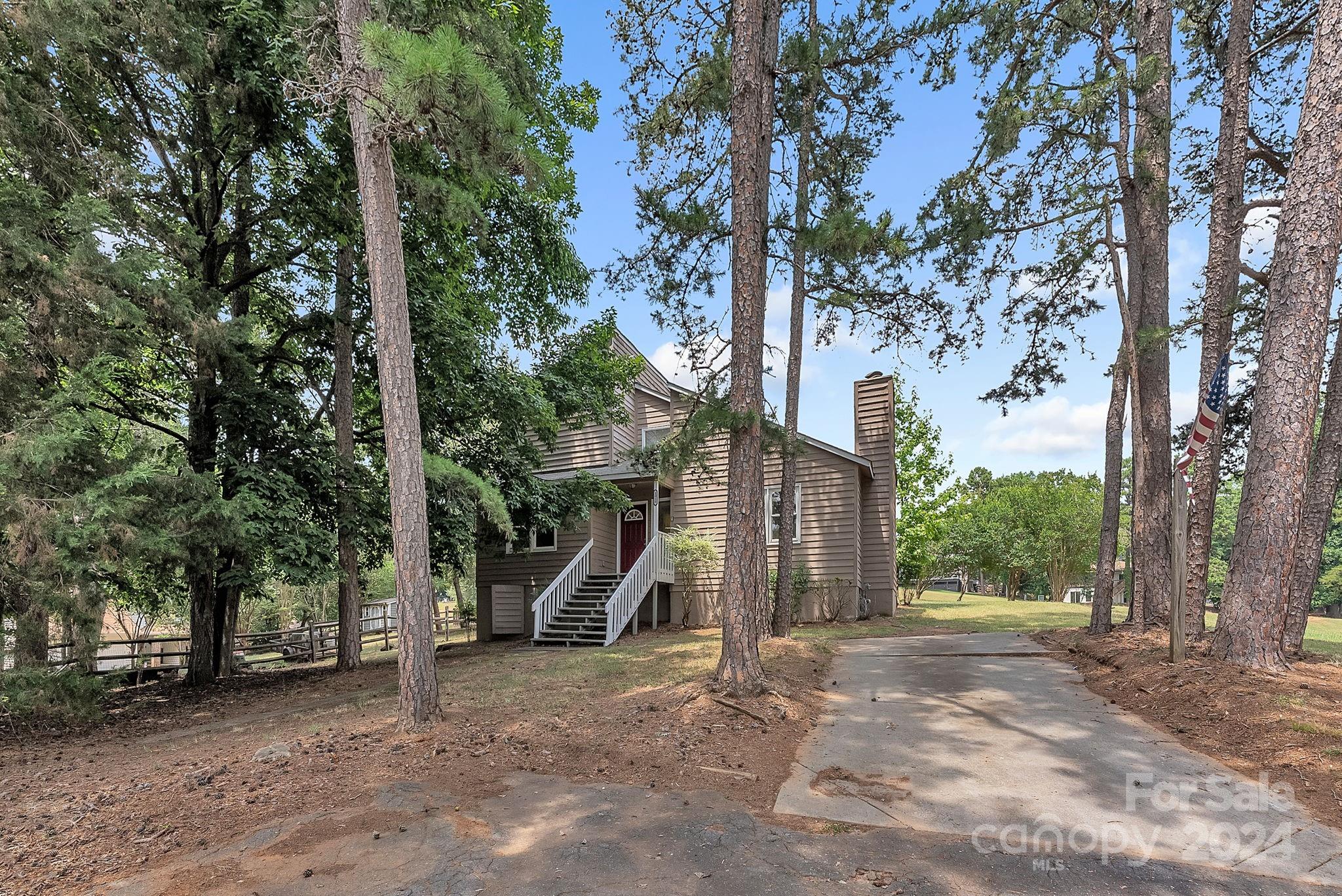 1018 Palmyra Drive Tega Cay, SC 29708 - Photo 2 of 36 a view of a house with a tree in the background
