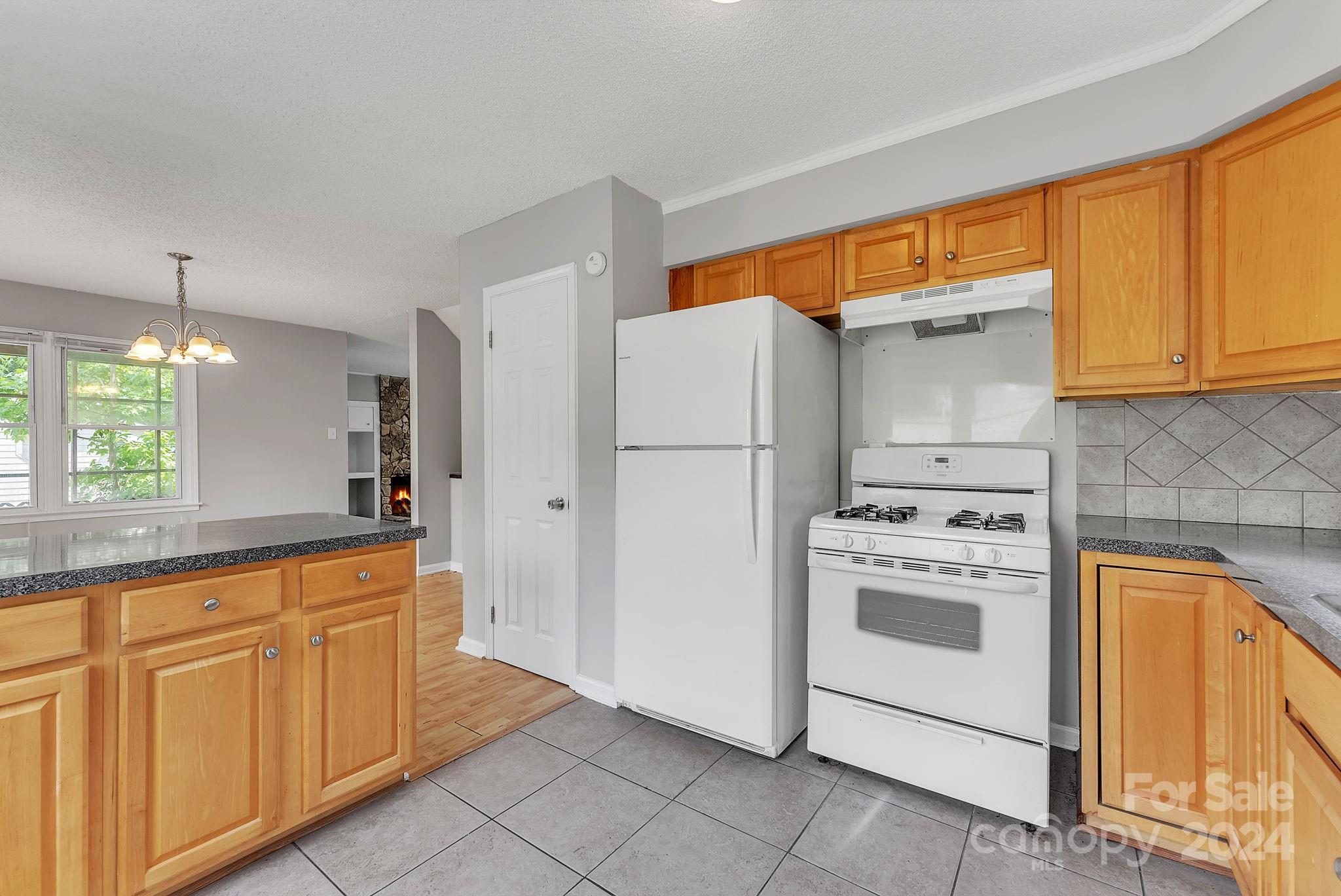 1018 Palmyra Drive Tega Cay, SC 29708 - Photo 22 of 36 a kitchen with stainless steel appliances granite countertop a refrigerator a sink and a stove