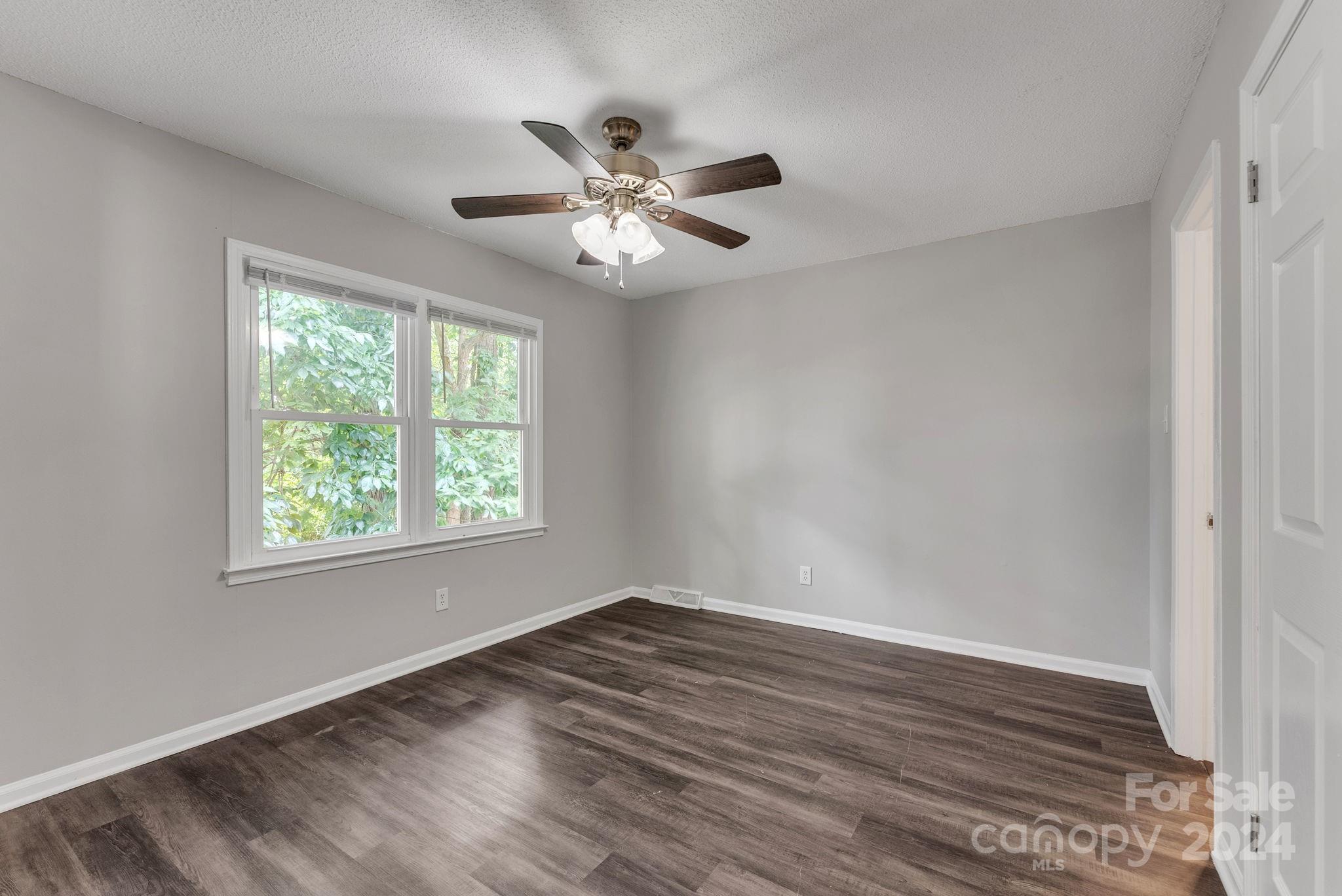 1018 Palmyra Drive Tega Cay, SC 29708 - Photo 24 of 36 a view of an empty room with wooden floor and a window