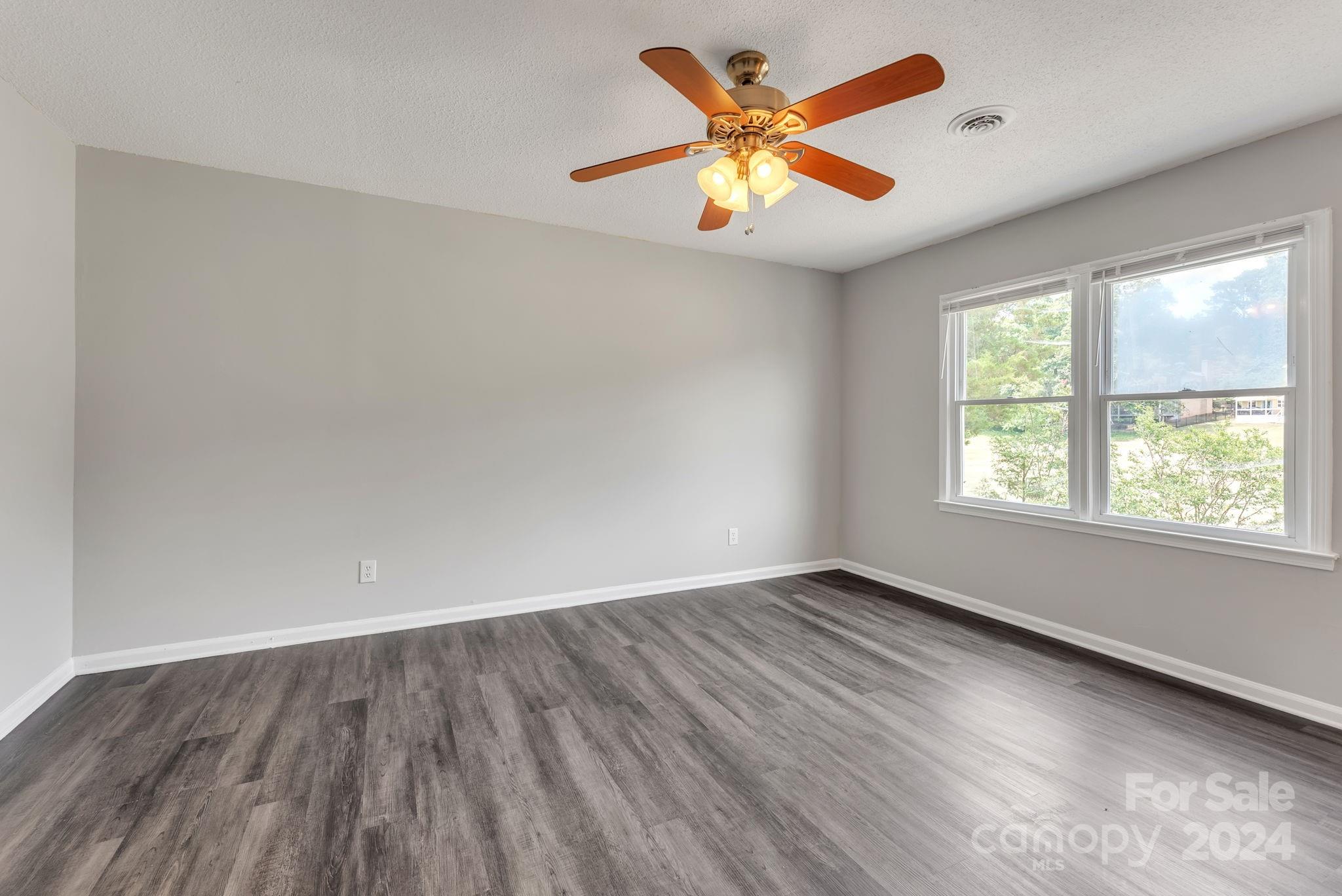 1018 Palmyra Drive Tega Cay, SC 29708 - Photo 31 of 36 an empty room with wooden floor and windows