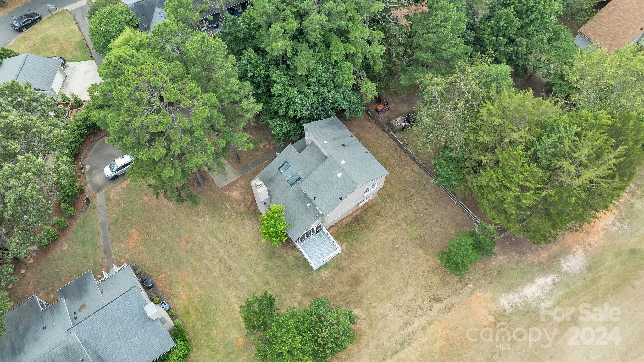 1018 Palmyra Drive Tega Cay, SC 29708 - Photo 6 of 36 an aerial view of a house with a yard and trees all around