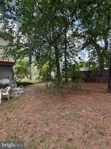 a view of a backyard with sitting area
