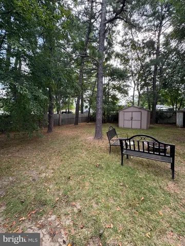 a view of a bench in a backyard