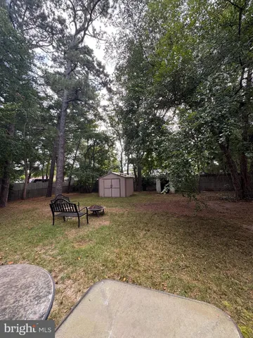 a backyard of a house with barbeque oven table and chairs