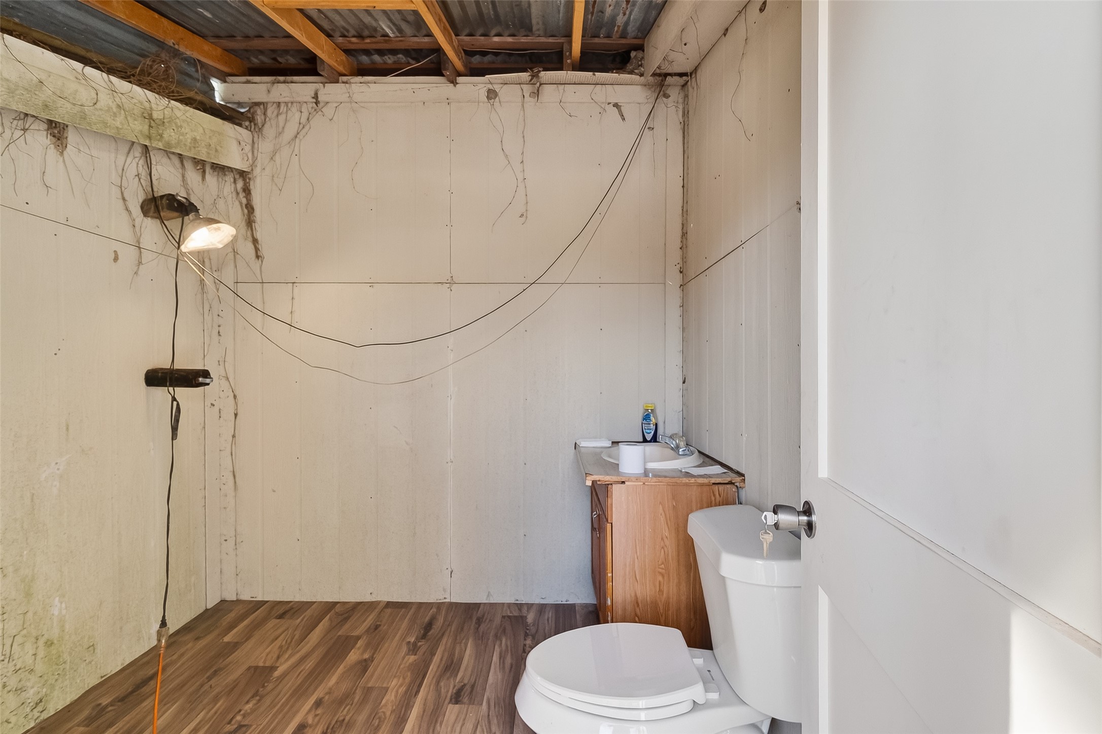 15627 Market Street Channelview, TX 77530 - Photo 25 of 35 a white toilet sitting next to a shower curtain