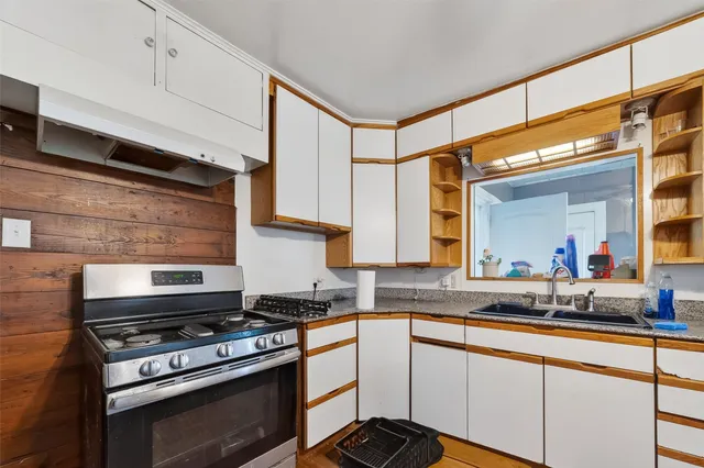 a kitchen with stainless steel appliances a stove and a sink