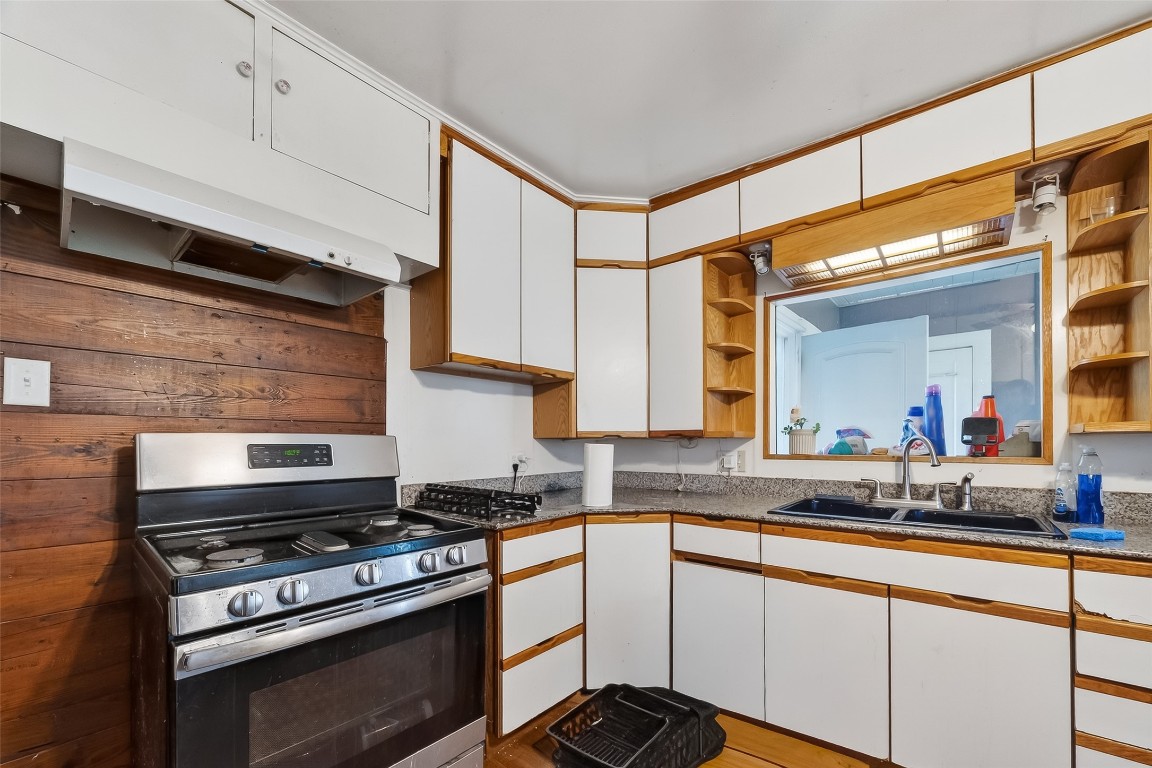 15627 Market Street Channelview, TX 77530 - Photo 8 of 35 a kitchen with stainless steel appliances a stove and a sink
