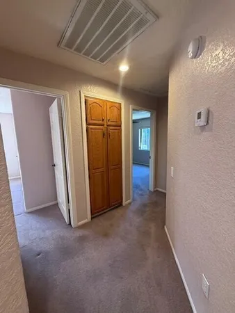 an empty room with closet and wooden floor