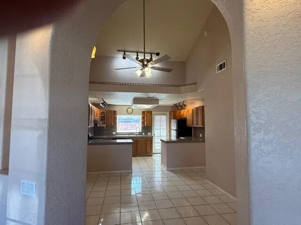 a kitchen with stainless steel appliances granite countertop a refrigerator and a stove top oven