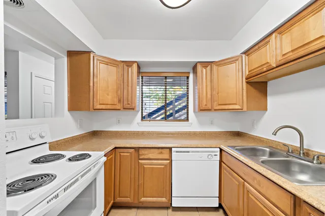 a kitchen with sink a stove and cabinets