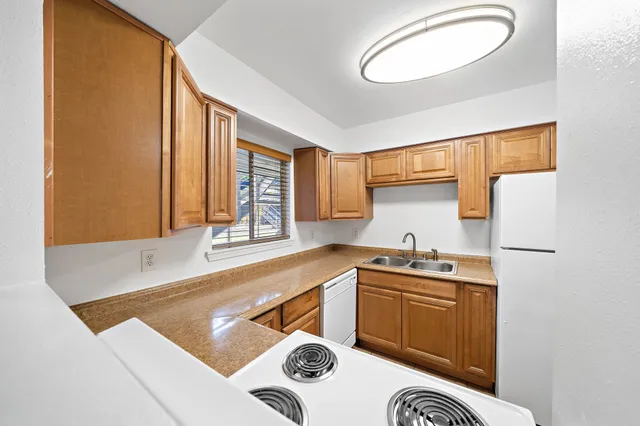 a kitchen with a sink a stove and a microwave