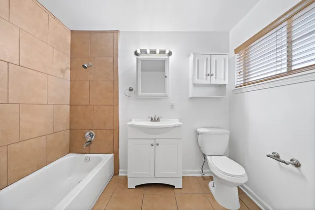 a bathroom with a sink a toilet and bathtub