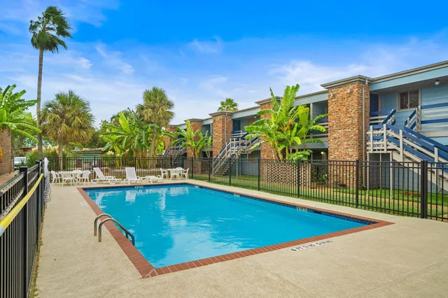 a swimming pool with outdoor seating and yard