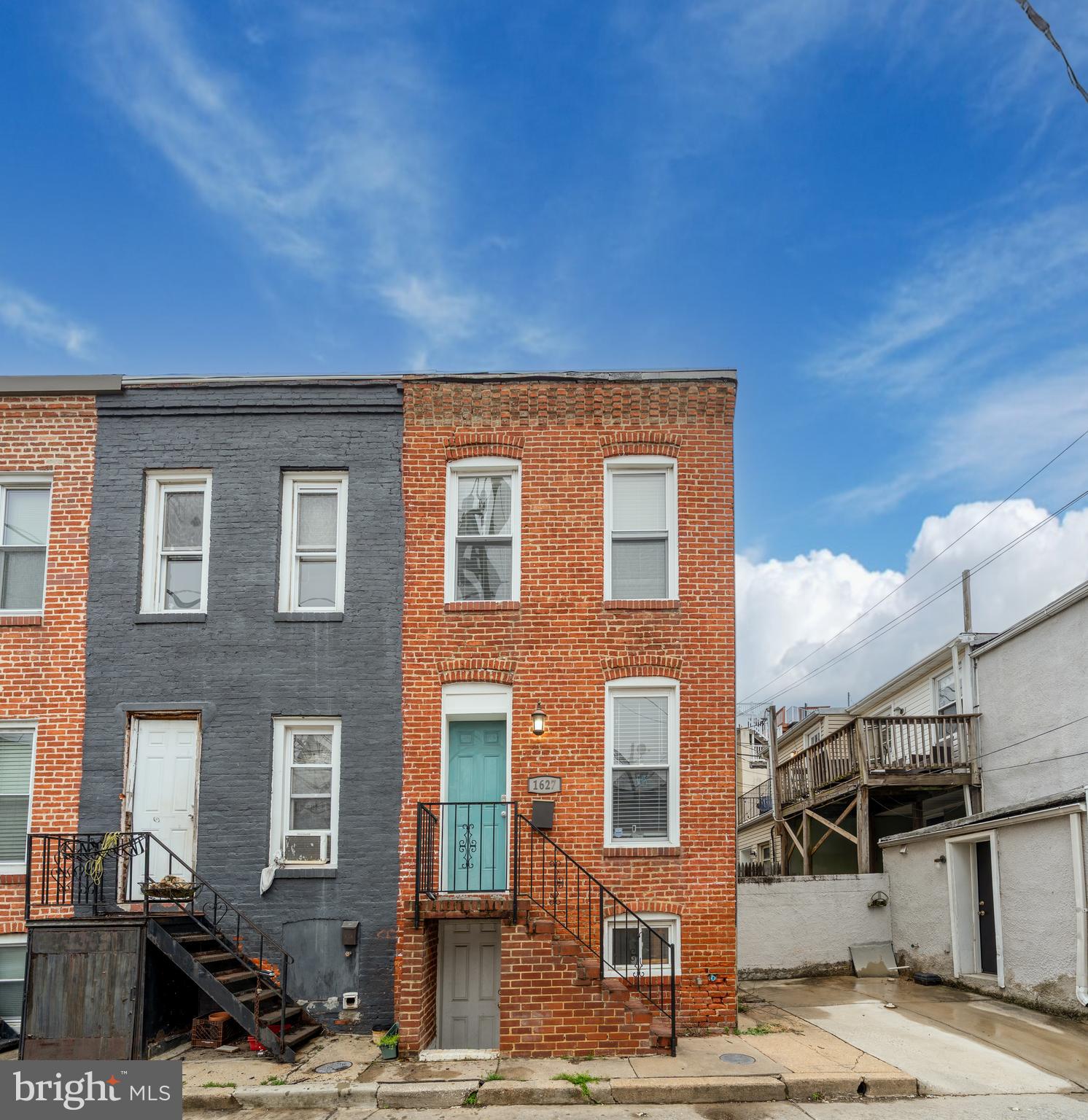 a front view of a building with a road