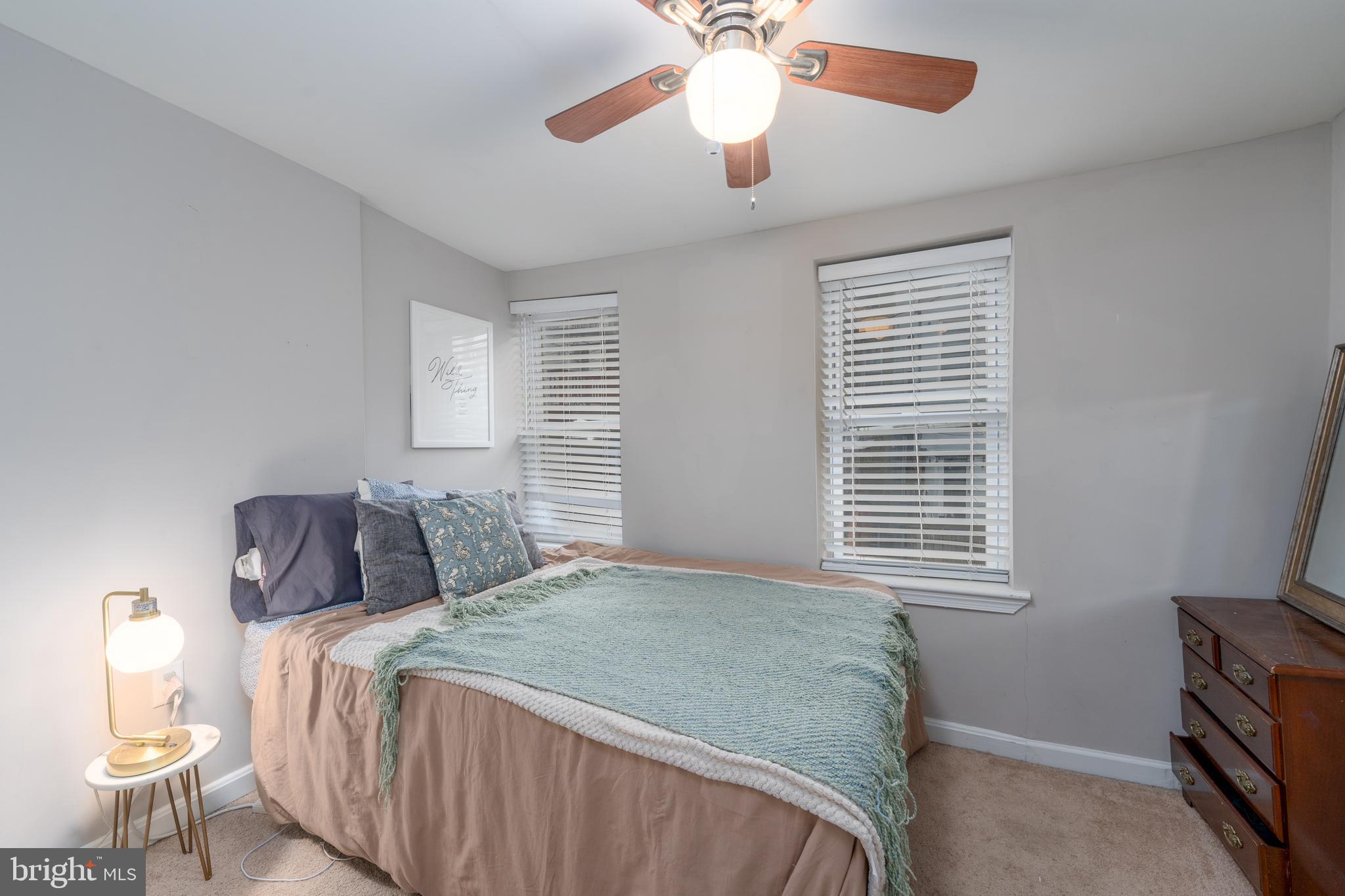 1627 Olive Street Baltimore, MD 21230 - Photo 12 of 22 a bedroom with a bed and a chandelier