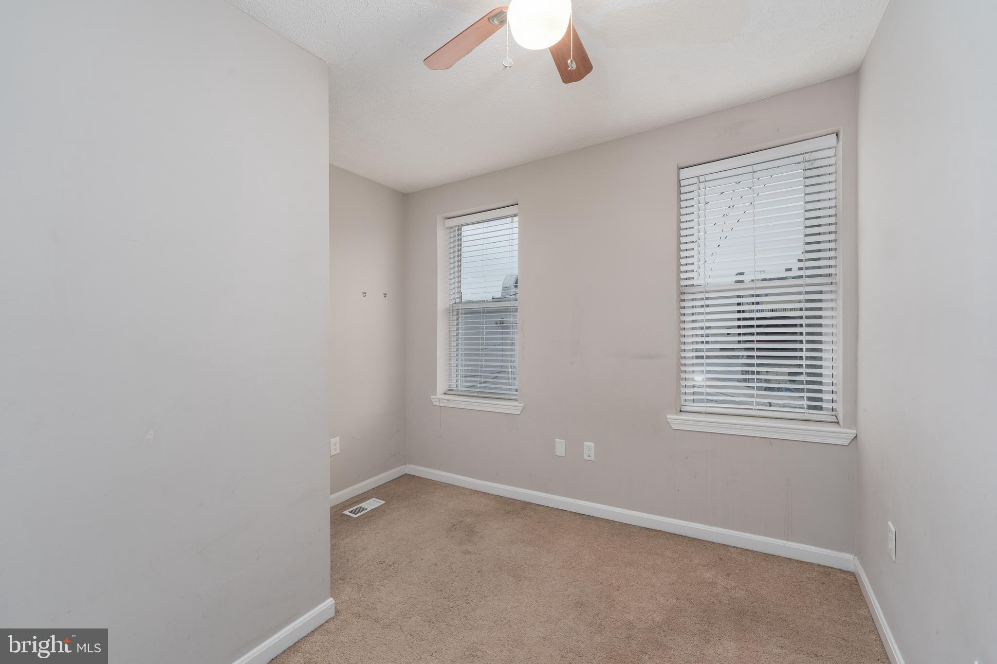 1627 Olive Street Baltimore, MD 21230 - Photo 15 of 22 an empty room with a window and a fan
