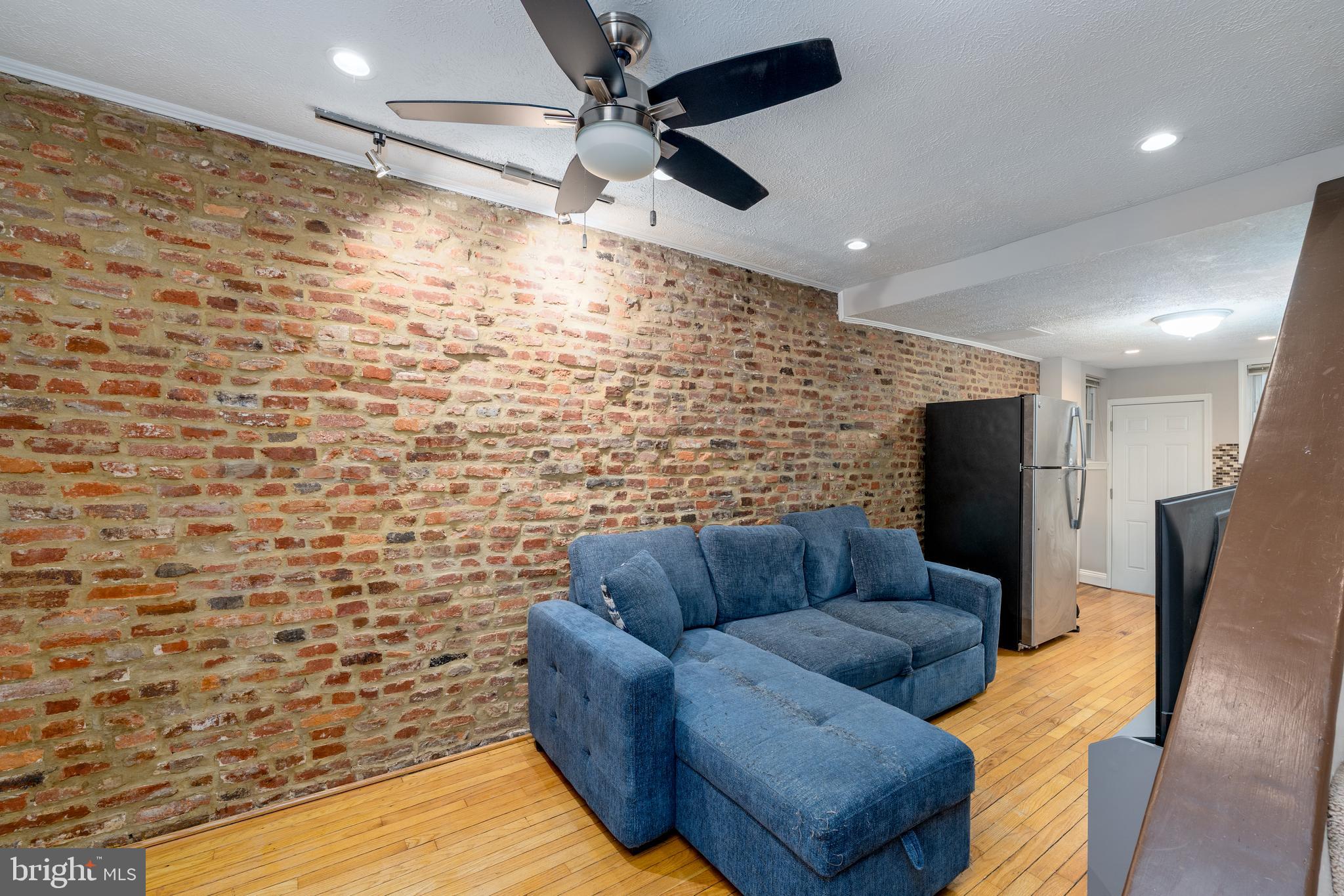 1627 Olive Street Baltimore, MD 21230 - Photo 4 of 22 a living room with furniture and a flat screen tv