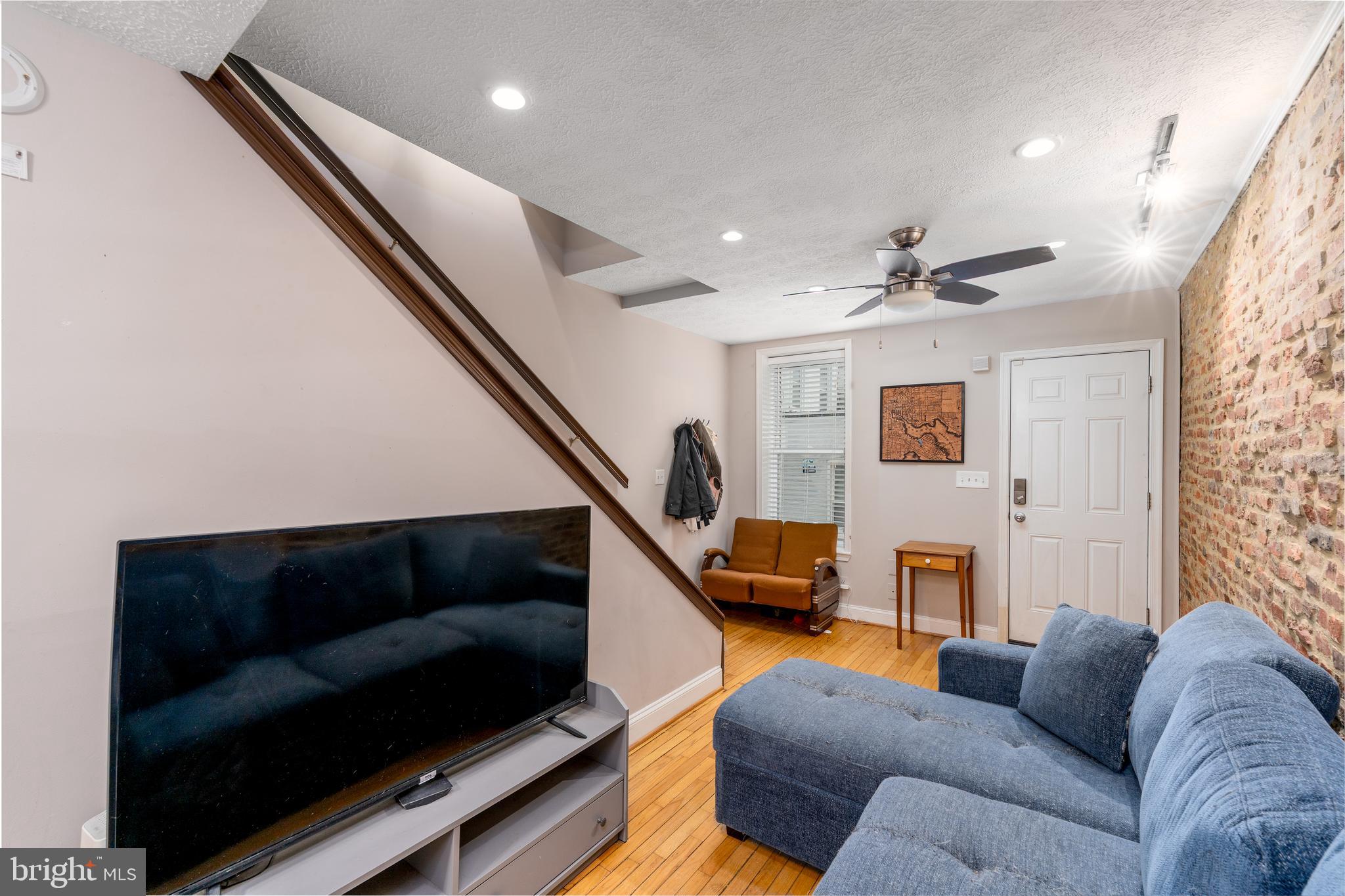 1627 Olive Street Baltimore, MD 21230 - Photo 5 of 22 a living room with furniture and a flat screen tv