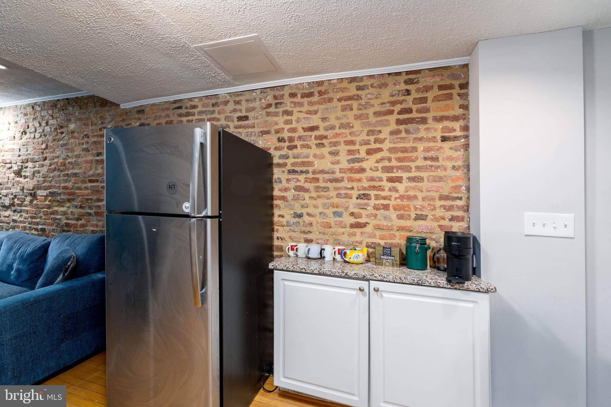 1627 Olive Street Baltimore, MD 21230 - Photo 7 of 22 a kitchen with a refrigerator and cabinets