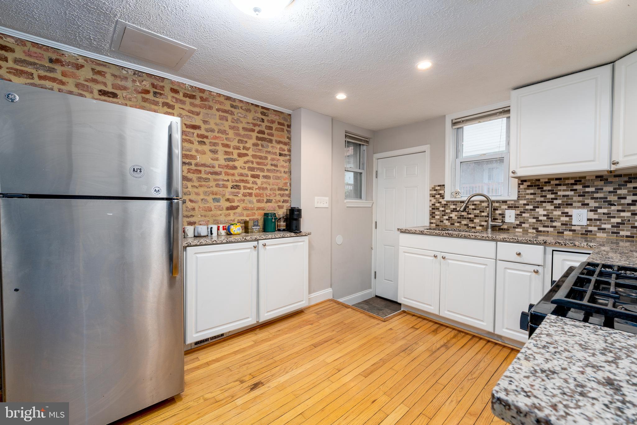 1627 Olive Street Baltimore, MD 21230 - Photo 9 of 22 a kitchen with a refrigerator and white cabinets