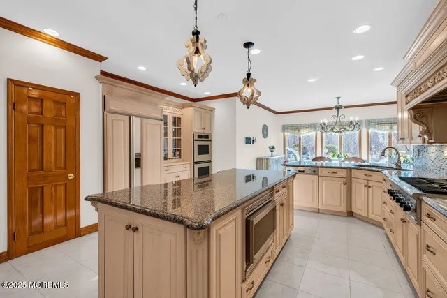 a kitchen with stainless steel appliances granite countertop a sink and refrigerator